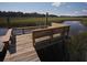 Wooden dock with built-in seating provides serene waterfront views at 8057 Point Of Pines Rd, Edisto Island, SC 29438