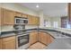 Modern kitchen with stainless steel appliances and wood cabinets at 102 Woodward Rd, Goose Creek, SC 29445