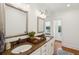 Double vanity bathroom with granite countertops and a large mirror at 175 Wentworth St # A, Charleston, SC 29401