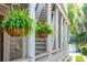 Charming front porch with hanging plants and white columns at 175 Wentworth St # A, Charleston, SC 29401