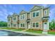 Tan townhouses with white doors and landscaping at 1103 Twin Rivers Drive # 71, Wando, SC 29492