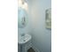 Small bathroom with pedestal sink and oval mirror at 1103 Twin Rivers Drive # 71, Wando, SC 29492