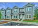 Gray townhouses with white doors and landscaping at 1103 Twin Rivers Drive # 71, Wando, SC 29492
