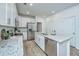 Modern kitchen with white cabinets, granite countertops, and stainless steel appliances at 1103 Twin Rivers Drive # 71, Wando, SC 29492