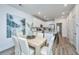 Bright dining room features a light wood table with white cushioned chairs at 1103 Twin Rivers Drive # 71, Wando, SC 29492