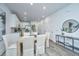 Dining area with light wood table and white chairs, adjacent to the kitchen at 1103 Twin Rivers Drive # 71, Wando, SC 29492