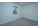 Simple bedroom with gray carpet and window at 1103 Twin Rivers Drive # 71, Wando, SC 29492