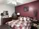 Bedroom with burgundy accent wall and vintage dresser at 6300 Badham Dr, Reevesville, SC 29471