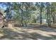 Large backyard with trees and a detached structure at 4429 Francis Younge Way, Hollywood, SC 29449