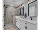 Modern bathroom with double vanity, white cabinets, and a walk-in shower at 4429 Francis Younge Way, Hollywood, SC 29449