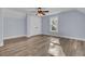 Sunlit bedroom with hardwood floors and ceiling fan at 4429 Francis Younge Way, Hollywood, SC 29449