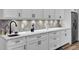 Basement wet bar with white cabinets, quartz countertops, and a patterned backsplash at 4429 Francis Younge Way, Hollywood, SC 29449