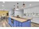 Blue kitchen island with wood countertop, built-in oven, and pendant lighting at 4429 Francis Younge Way, Hollywood, SC 29449
