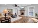 Spacious living room features a fireplace, hardwood floors, and large windows at 4429 Francis Younge Way, Hollywood, SC 29449