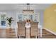 White table and wicker chairs in the dining area near access to back deck at 4429 Francis Younge Way, Hollywood, SC 29449