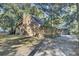Brown house exterior with a deck and surrounding trees at 4429 Francis Younge Way, Hollywood, SC 29449