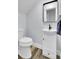 Small, modern bathroom with white vanity and wood-look floors at 4429 Francis Younge Way, Hollywood, SC 29449