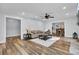 Open living room with hardwood floors and views to dining and kitchen areas at 4429 Francis Younge Way, Hollywood, SC 29449