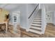 Elegant staircase with hardwood floors and white risers at 4429 Francis Younge Way, Hollywood, SC 29449