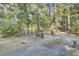 Gravel driveway leading to a charming house nestled in a wooded area at 4429 Francis Younge Way, Hollywood, SC 29449