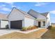 White house with dark gray garage door and landscaping at 178 Garden Gate Way, Summerville, SC 29486