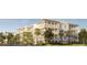 Building exterior with balconies, palm trees, and a paved road at 540 Helmsman St # 1225, Daniel Island, SC 29492