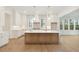 Modern kitchen with white cabinets, a large island, and gold light fixtures at 3904 Delinger Dr, Mount Pleasant, SC 29466