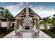 Relaxing outdoor patio with a large stone fireplace and rocking chairs at 3904 Delinger Dr, Mount Pleasant, SC 29466
