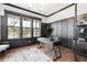 Home office with dark-paneled walls, hardwood floors, and built-ins at 3904 Delinger Dr, Mount Pleasant, SC 29466