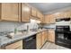 Modern kitchen with light wood cabinets and black appliances at 21 Rivers Point Row # 4B, Charleston, SC 29412