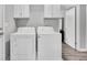 Laundry room with washer, dryer, and white cabinets at 21 Rivers Point Row # 4B, Charleston, SC 29412