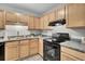 Kitchen with light wood cabinets and black appliances at 21 Rivers Point Row # 4B, Charleston, SC 29412