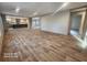 Open concept living room with kitchen view and wood-look flooring at 317 Marion Rd, Dorchester, SC 29437