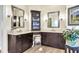 Elegant bathroom with double vanity, corner cabinet, and neutral tile floors at 169 Marsh Island Dr, Kiawah Island, SC 29455