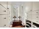 Bright walk-in closet featuring built-in shelving and drawers at 169 Marsh Island Dr, Kiawah Island, SC 29455