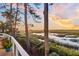 Deck overlooking peaceful marsh views at sunset at 169 Marsh Island Dr, Kiawah Island, SC 29455