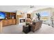 Cozy sitting room with fireplace, built-in shelving, and water views at 169 Marsh Island Dr, Kiawah Island, SC 29455