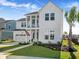 Two-story white farmhouse with a three-car garage and landscaped lawn at 197 Denham St, Summerville, SC 29486