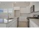 White kitchen with stainless steel appliances and island at 309 Trailmore Ln, Summerville, SC 29486