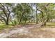 Spacious backyard with lush trees and grassy area at 700 Daniel Ellis Dr # 13301, Charleston, SC 29412