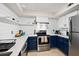 Modern kitchen with white shiplap, stainless steel appliances, and blue cabinets at 700 Daniel Ellis Dr # 13301, Charleston, SC 29412