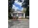 Charming white cottage with red trim, front porch, and ample parking at 507 E 5Th N St, Summerville, SC 29483