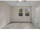 Bedroom with grey flooring, two windows, and access to a bathroom at 164 Aleene Drive Dr, Summerville, SC 29485