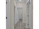 Hallway with light walls, grey flooring, and several doors at 164 Aleene Drive Dr, Summerville, SC 29485