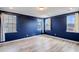 Spacious bedroom with blue walls, light wood floors, and multiple windows at 218 Symphony Ave, Summerville, SC 29486