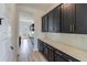 Kitchen pantry with white quartz countertops and dark wood cabinets at 218 Symphony Ave, Summerville, SC 29486