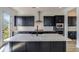 Modern kitchen island with white quartz countertop and black cabinetry at 218 Symphony Ave, Summerville, SC 29486