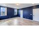 Bright bedroom with blue walls, light wood floors, and a white door at 218 Symphony Ave, Summerville, SC 29486