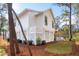 White two story home with white board and batten siding at 6052 Honey Hole Haven, Johns Island, SC 29455