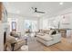 Open concept living room with a neutral sofa and chairs, and views into the kitchen and dining area at 6052 Honey Hole Haven, Johns Island, SC 29455